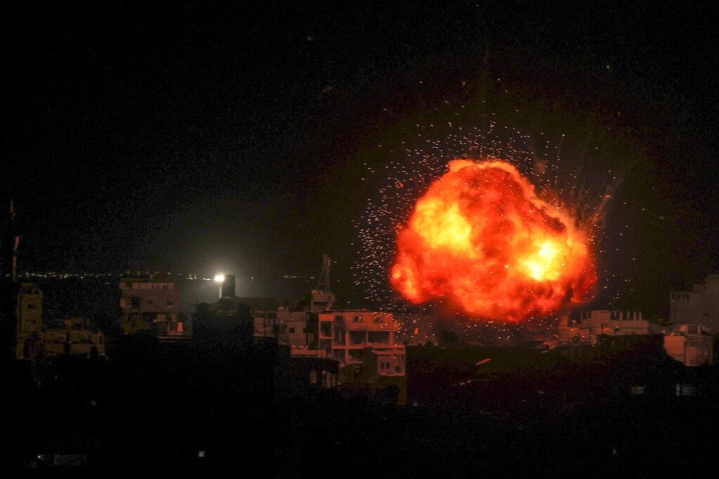 a fireball errupts during isreali bombardment on rafah in the southern gaza strip