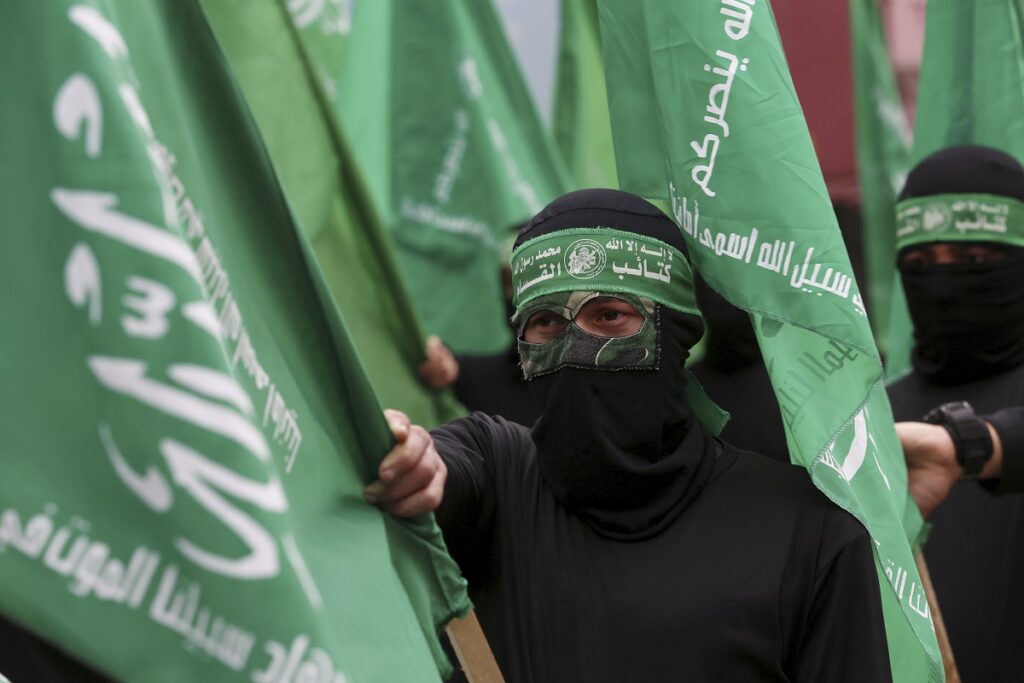 masked hamas militants wave their green flags